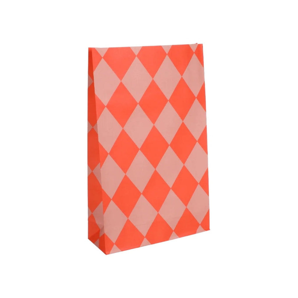 A paper party favor bag with a vibrant orange and light pink harlequin diamond pattern, shown standing upright on a plain white background.