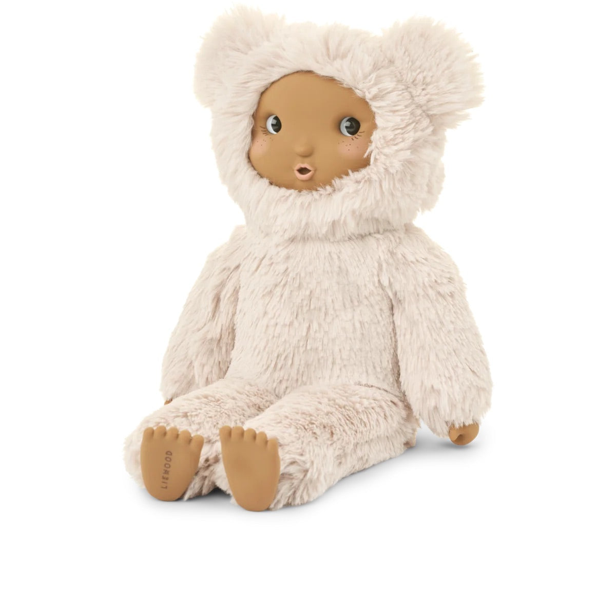 A plush doll seated against a plain white background, wearing a shaggy cream hooded outfit with bear ears and tan skin-toned face and feet. The brand name 'Jelly' is visible on the sole of one foot.