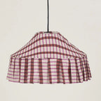 Plaid patterned lampshade on a plain background