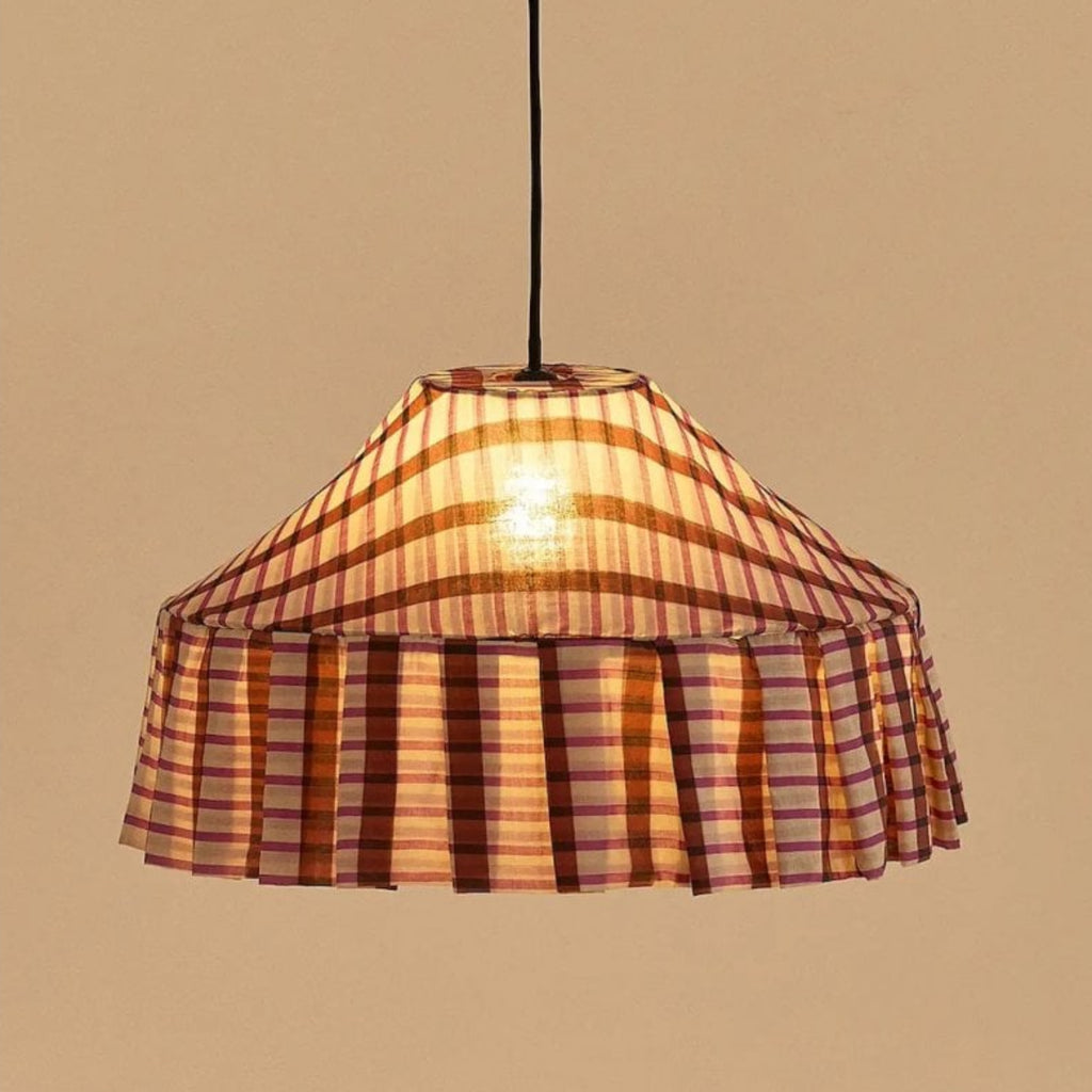 Plaid patterned pendant light against a beige background