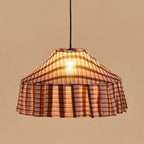Plaid patterned pendant light against a beige background