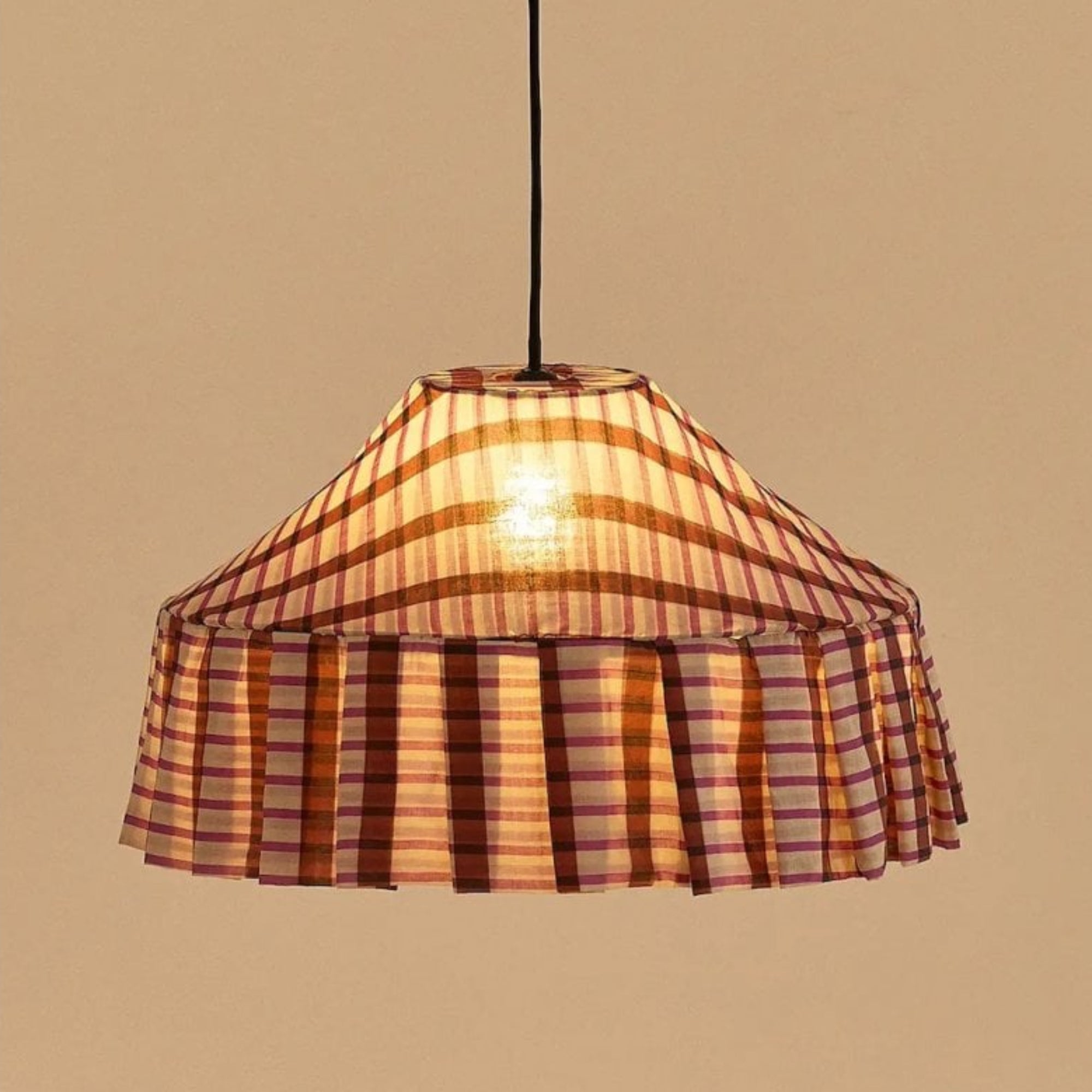 Plaid patterned pendant light against a beige background