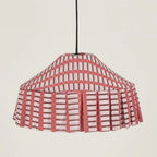 Pendant light with a red and white checkered shade on a plain background