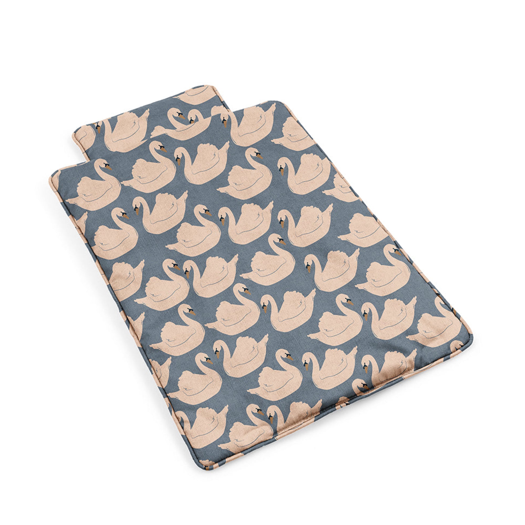 Two folded fabric swatches with a swan pattern on a white background