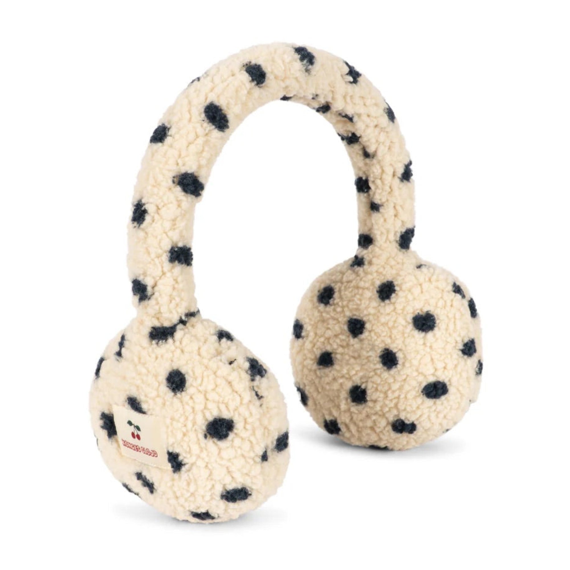 A plush dog toy shaped like over-ear headphones, made from cream-colored textured fabric with black spots, resembling a dalmatian pattern. A small red tag with the brand name 'KONG' is visible on the left earcup.
