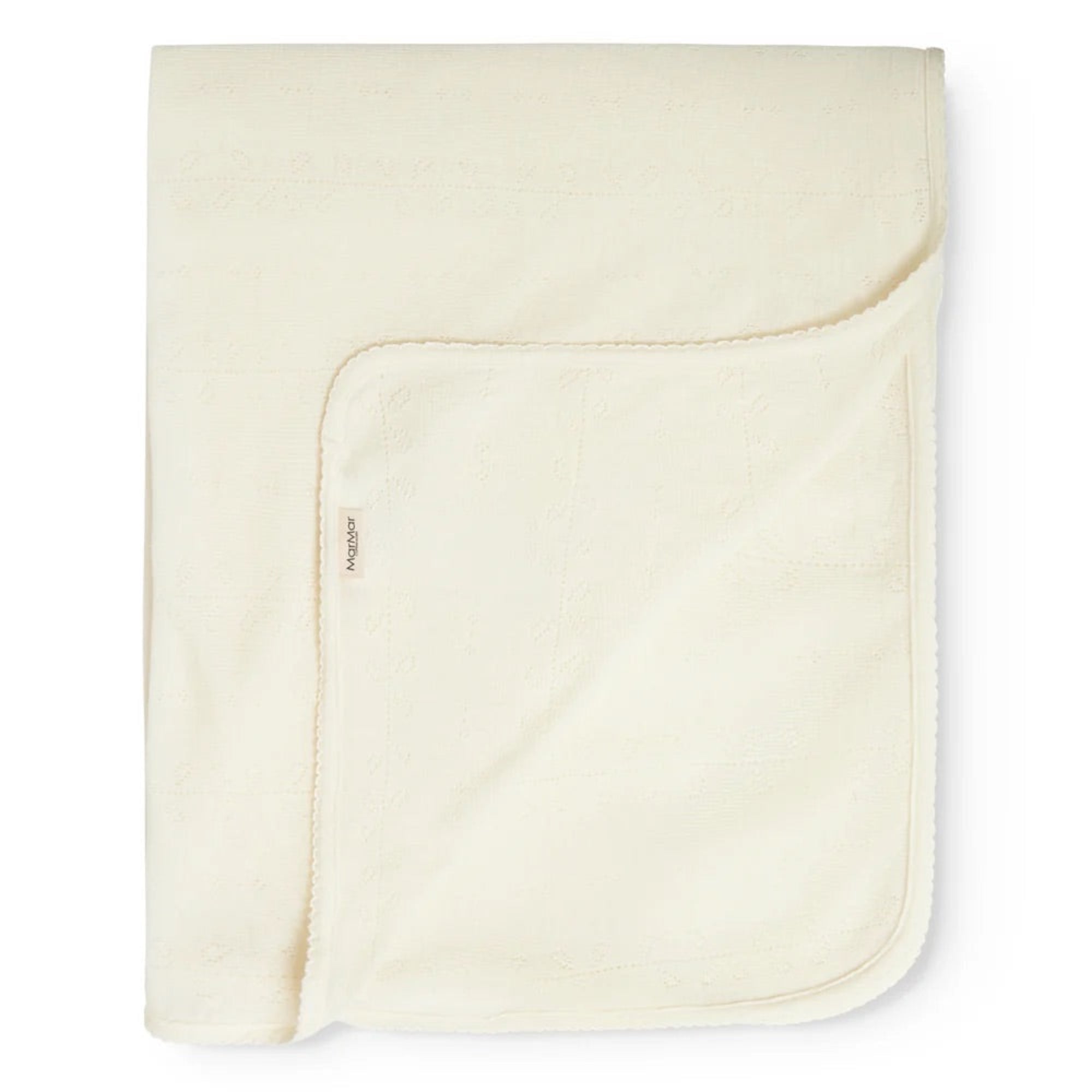 A folded cream-colored cotton blanket with a soft, plush fleece reverse side, shown on a clean white background.