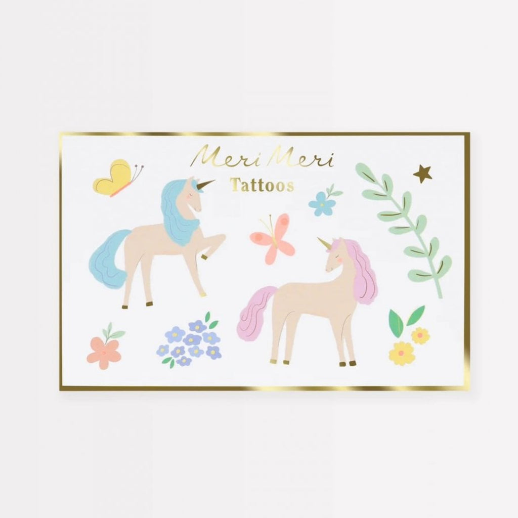 Unicorn-themed tattoos with decorative elements on a white background