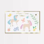 Unicorn-themed tattoos with decorative elements on a white background