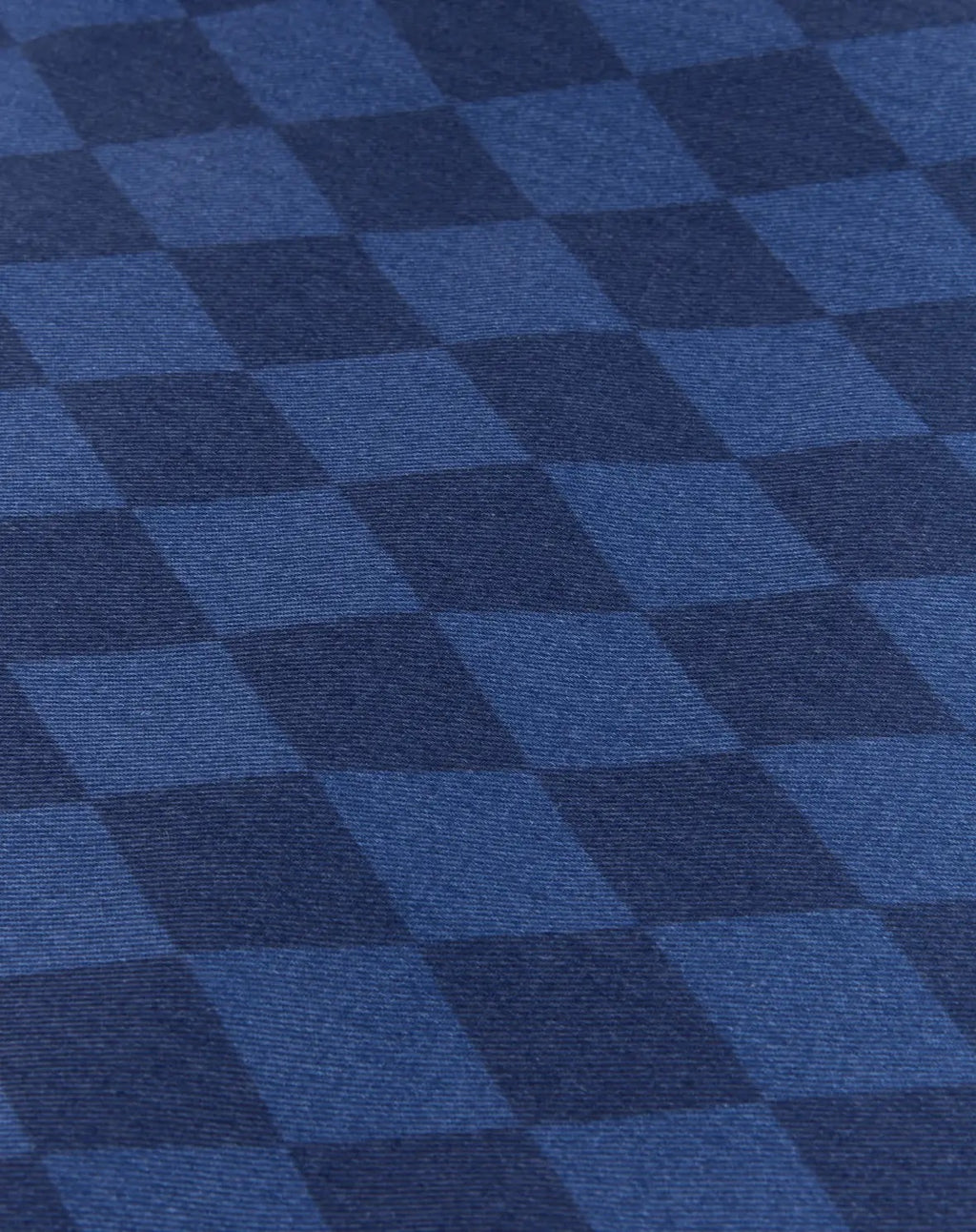 A close-up of a blue and navy checkered fabric pattern with a visible woven texture.