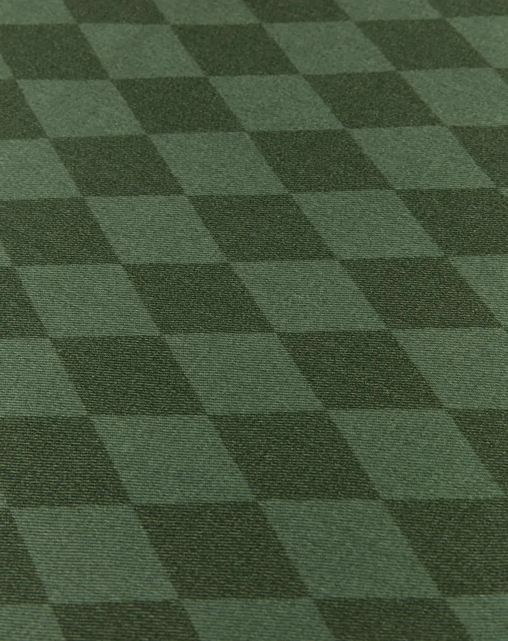 A close-up of a dark green checkered fabric or carpet texture with alternating lighter and darker green squares.