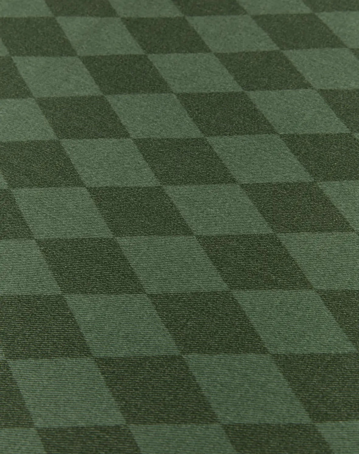 A close-up of a dark green checkered fabric or carpet texture with alternating lighter and darker green squares.