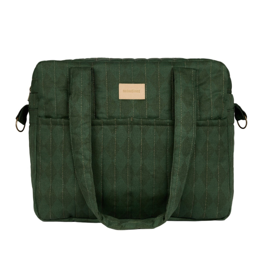 A dark green pinstriped tote bag with dual top handles, side pockets with black zipper pulls, and a small tan leather brand patch on the front, shown against a plain white background.