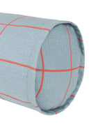 A close-up of a cylindrical cushion or pillow upholstered in a light blue-gray woven fabric with a thin red windowpane plaid pattern, shown on a plain white background.